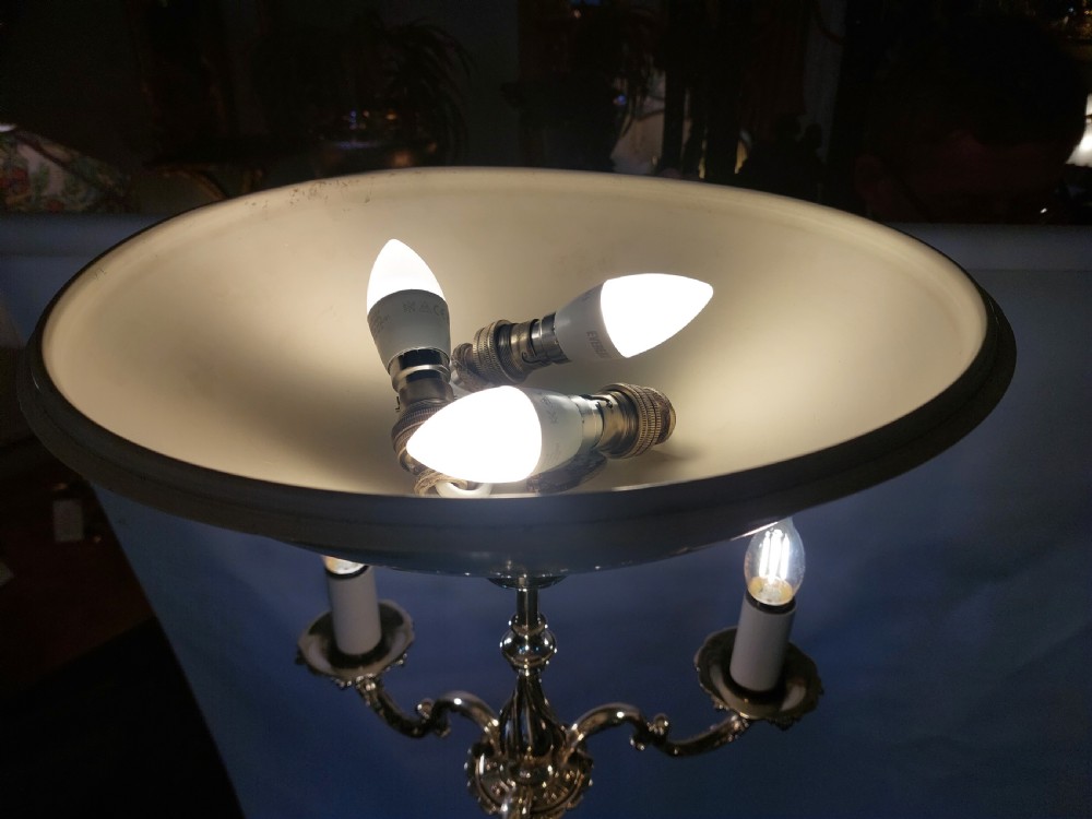 A pair of 1920s polished brass standard floor lamps featuring reeded columns, decorative cast bases, and pleated fabric shades. View XIII
