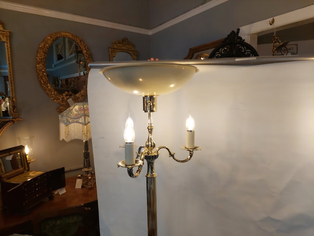 A pair of 1920s polished brass standard floor lamps featuring reeded columns, decorative cast bases, and pleated fabric shades. View XIV