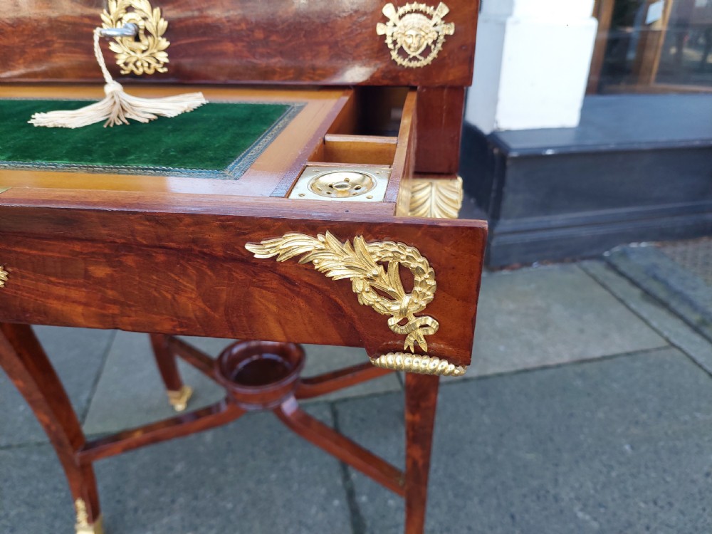 Late nineteenth-century French mahogany writing desk featuring an open mirrored lid, gilt bronze mounts, pull-out drawer with green velvet writing surface, and candle slides. View II