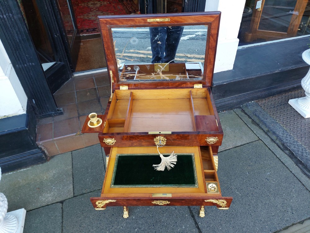 Late nineteenth-century French mahogany writing desk featuring an open mirrored lid, gilt bronze mounts, pull-out drawer with green velvet writing surface, and candle slides. View IV