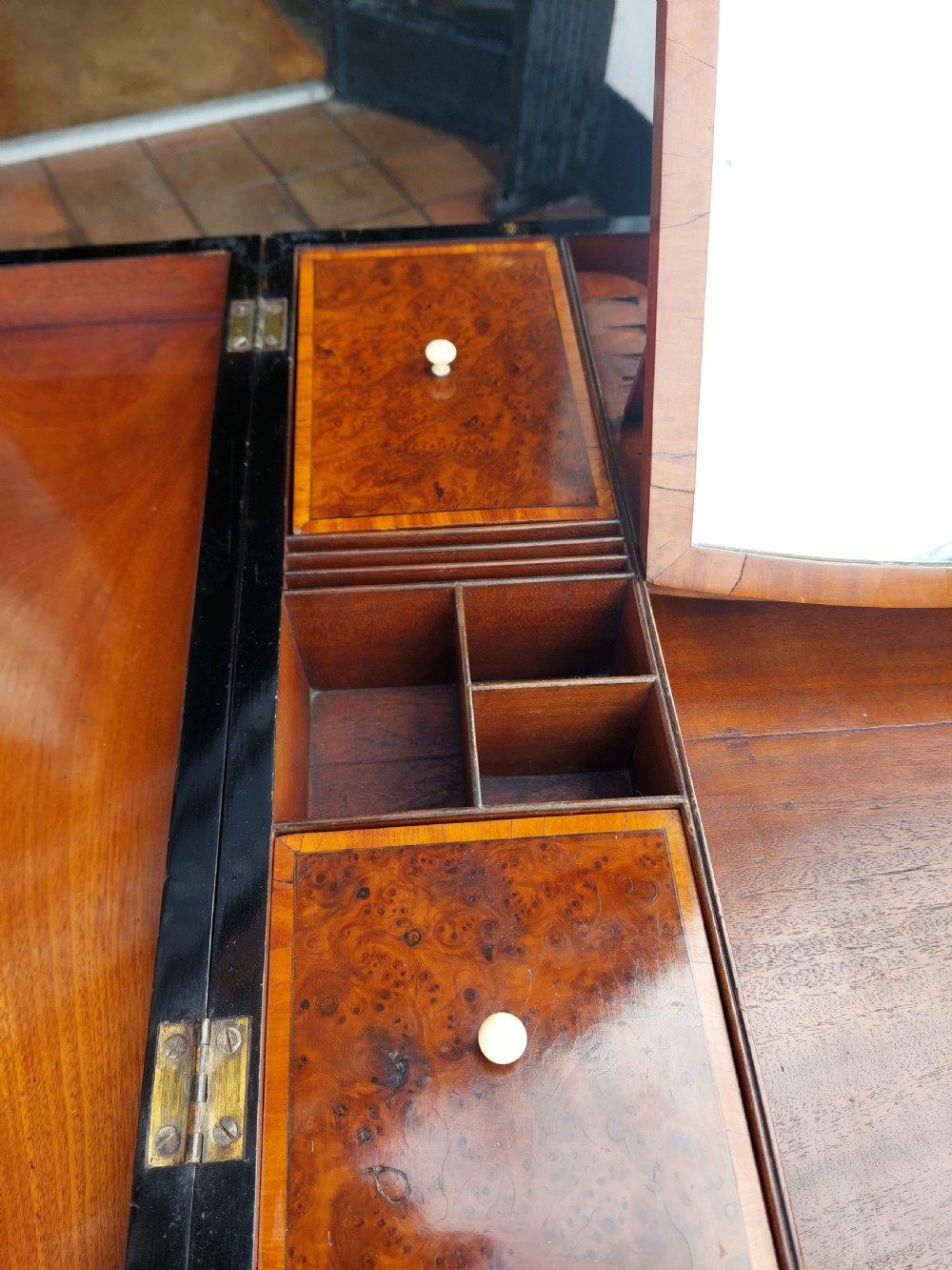 A George III satinwood and mahogany gentlemans wash stand with extended hinged top flaps, an upright central mirror, and tapered inlaid legs on brass castors. View VI