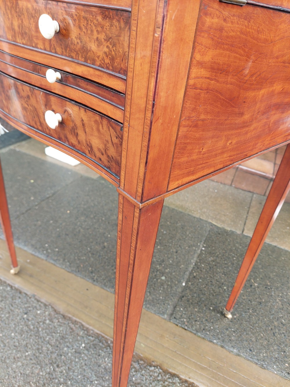 A George III satinwood and mahogany gentlemans wash stand with extended hinged top flaps, an upright central mirror, and tapered inlaid legs on brass castors. View XIII
