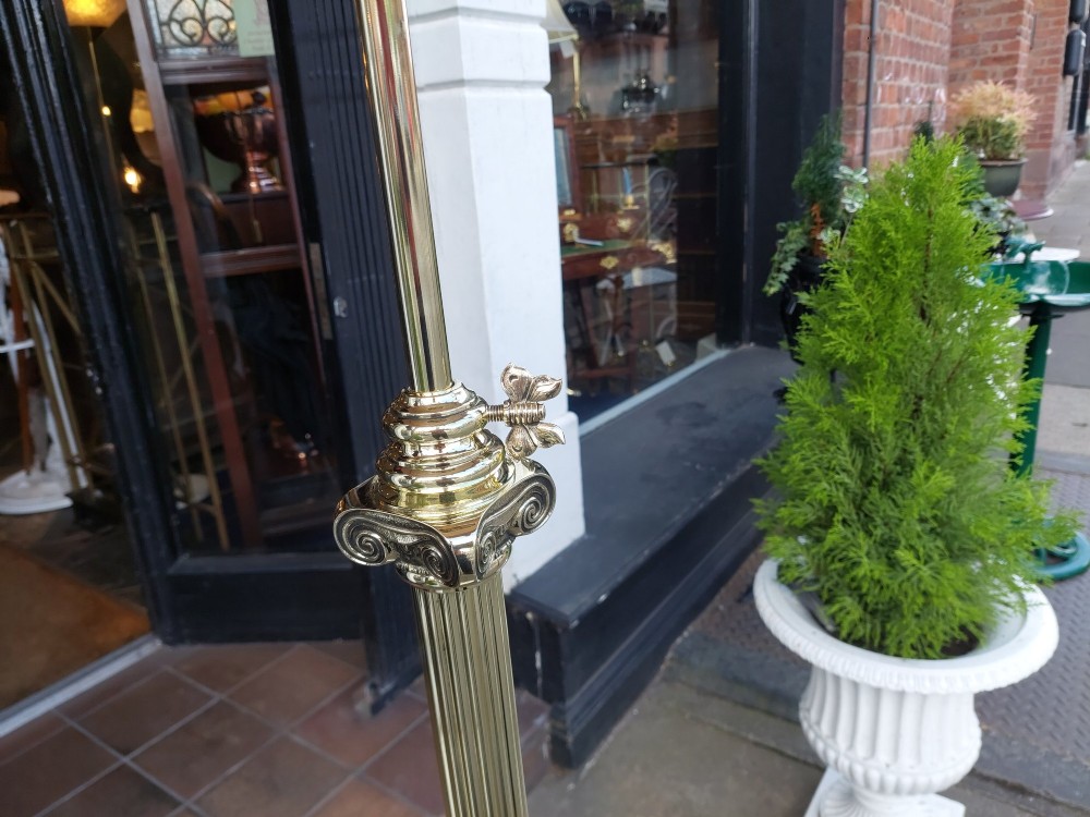 A Victorian Neoclassical brass floor lamp featuring a fluted column shaft, Corinthian capital detail, stepped base on claw feet, and a cream fringed fabric shade. View III