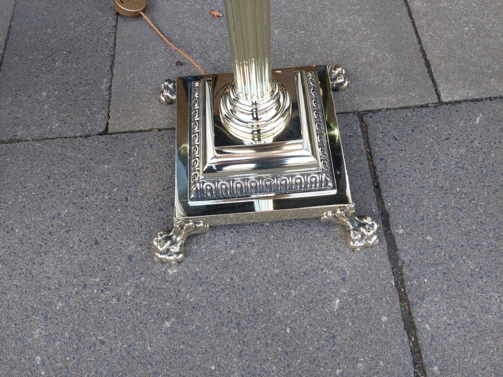 A Victorian Neoclassical brass floor lamp featuring a fluted column shaft, Corinthian capital detail, stepped base on claw feet, and a cream fringed fabric shade. View V