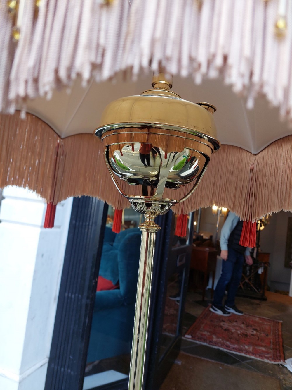 A Victorian Neoclassical brass floor lamp featuring a fluted column shaft, Corinthian capital detail, stepped base on claw feet, and a cream fringed fabric shade. View VI