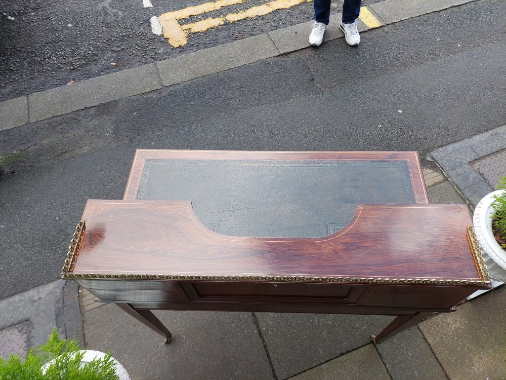 Late Victorian inlaid mahogany writing desk featuring an upper mirror-backed superstructure with brass gallery, leather writing surface, floral marquetry, and tapered legs on castors. View III
