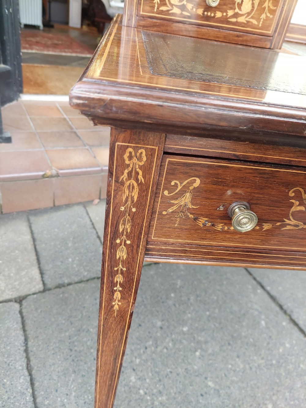 Late Victorian inlaid mahogany writing desk featuring an upper mirror-backed superstructure with brass gallery, leather writing surface, floral marquetry, and tapered legs on castors. View IX