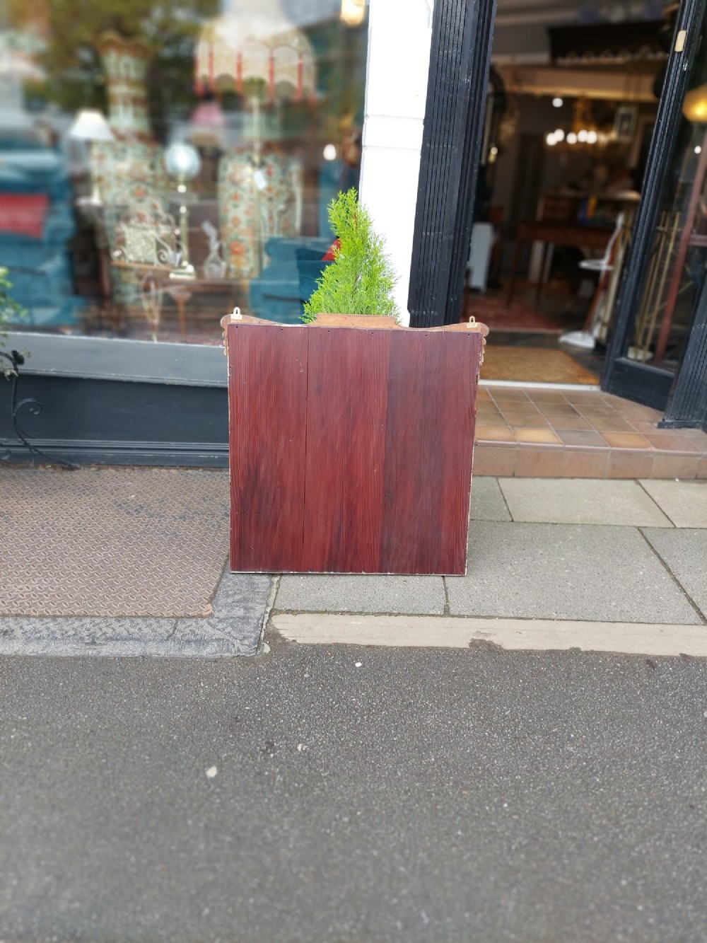 An Edwardian rosewood rectangular overmantel mirror featuring decorative marquetry inlays in the upper corners, a central carved cresting, and a bevelled glass plate. View VI