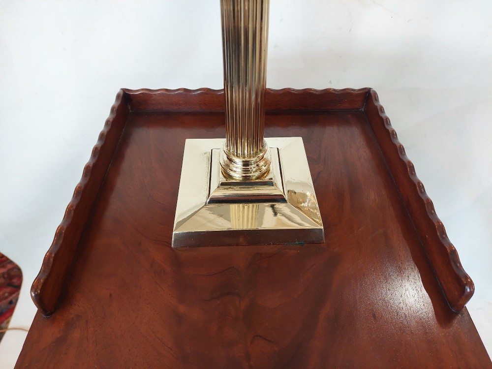 A late 19th-century brass table oil lamp featuring a reeded column, square base, clear glass reservoir, and an etched pink glass shade with a ruffled rim. View II