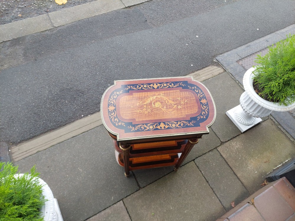 An antique Victorian marquetry whatnot table featuring floral inlay on the top surface, two lower tiers, fluted legs, and gilt-metal mounts. View IV