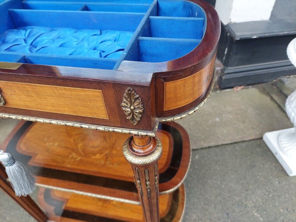 An antique Victorian marquetry whatnot table featuring floral inlay on the top surface, two lower tiers, fluted legs, and gilt-metal mounts. View IX