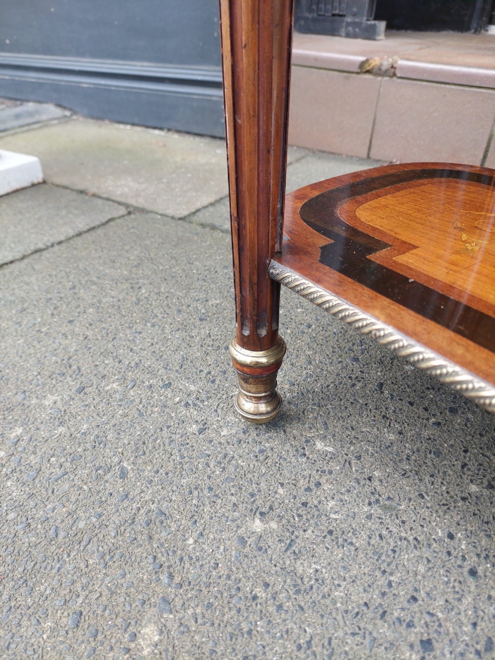 An antique Victorian marquetry whatnot table featuring floral inlay on the top surface, two lower tiers, fluted legs, and gilt-metal mounts. View X