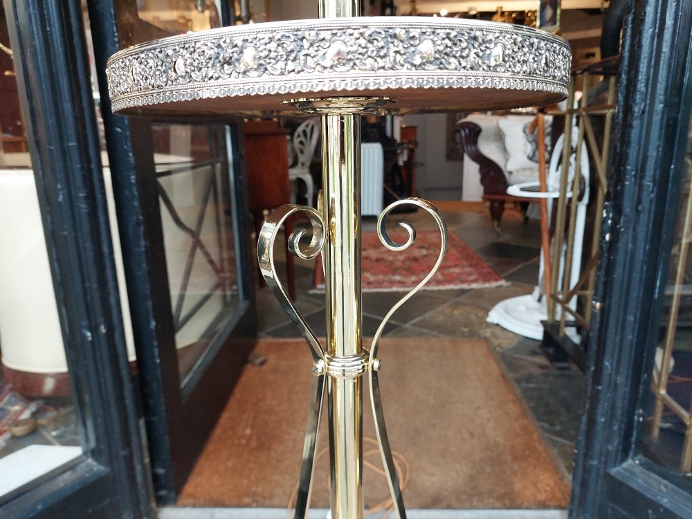 An Edwardian brass standard floor lamp featuring a scrollwork tripod base, an integrated circular tray table, and a fabric shade with fringe and tassels. View V
