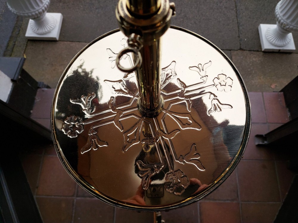 An Edwardian brass standard floor lamp featuring a scrollwork tripod base, an integrated circular tray table, and a fabric shade with fringe and tassels. View VII