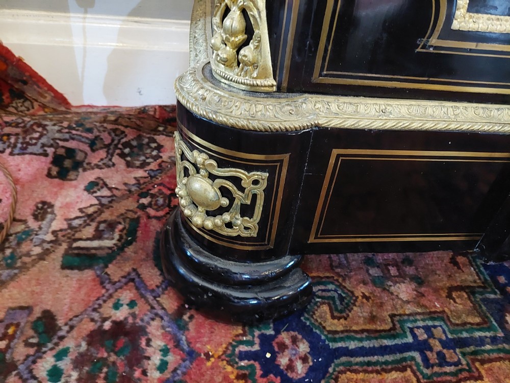 A French Napoleon III ebonised side cabinet featuring a white marble top, gold brass inlays, gilt-bronze ormolu mounts, and a central oval medallion. View IX