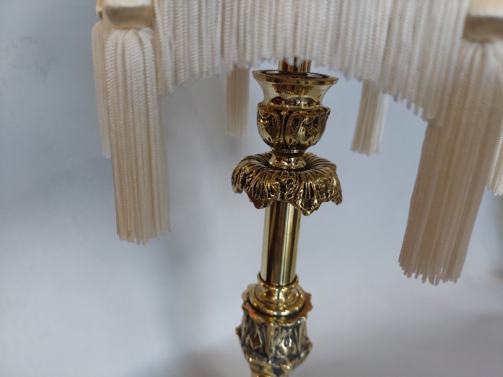 A pair of early 19th-century brass candlestick table lamps with claw feet and rose-coloured fringed fabric shades. View IV