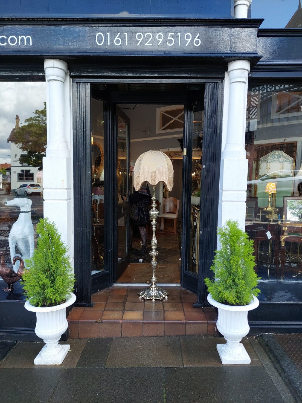 A pair of ornate silvered brass standard lamps featuring detailed turned baluster stems, lobed bases, and cream domed fabric shades with fringed edging. View II