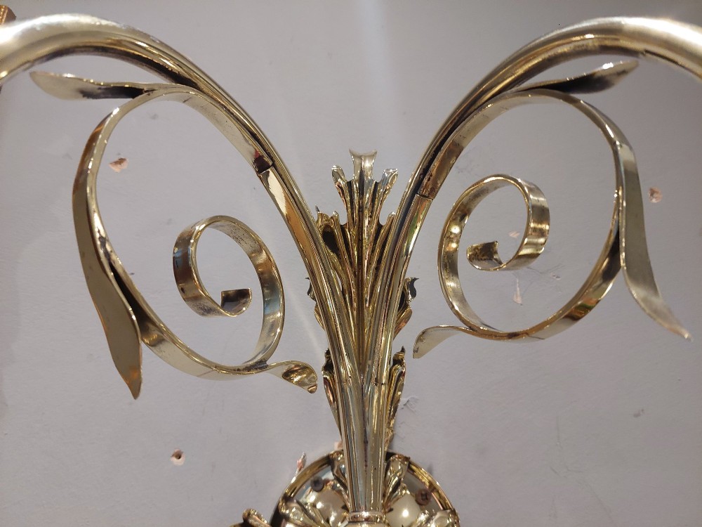 A pair of Edwardian cast brass double-arm wall sconces featuring leaf backplates and cut glass bell-shaped shades. View VI