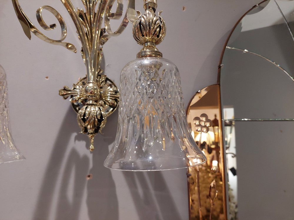 A pair of Edwardian cast brass double-arm wall sconces featuring leaf backplates and cut glass bell-shaped shades. View VII