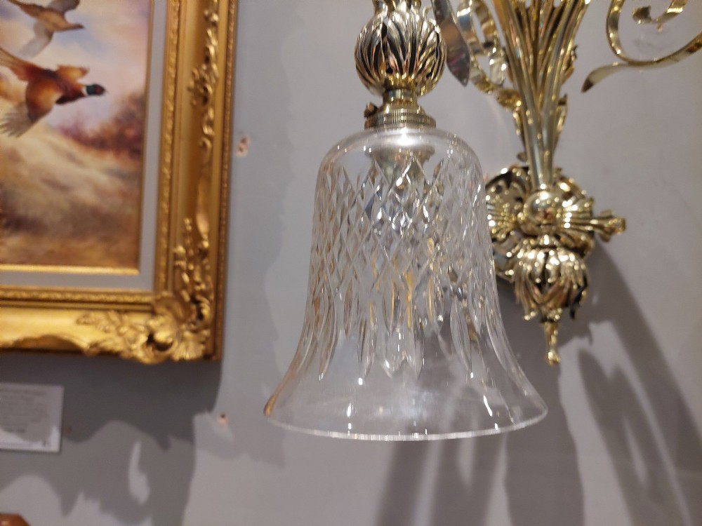 A pair of Edwardian cast brass double-arm wall sconces featuring leaf backplates and cut glass bell-shaped shades. View VIII