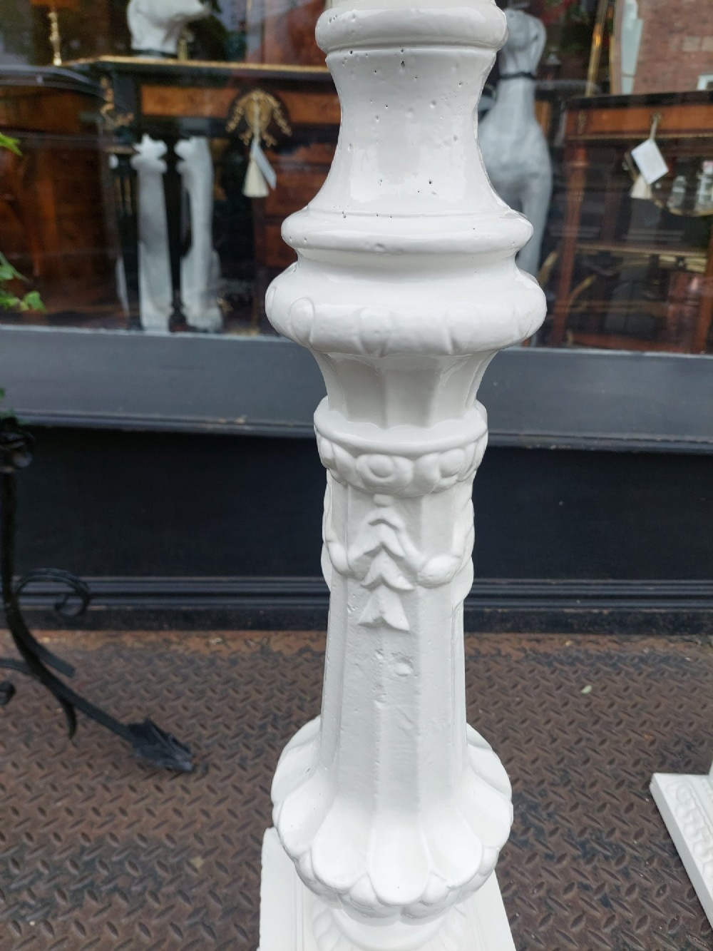 A pair of late 19th-century white painted cast iron garden pedestals with turned column shafts and floral relief square bases. View IV