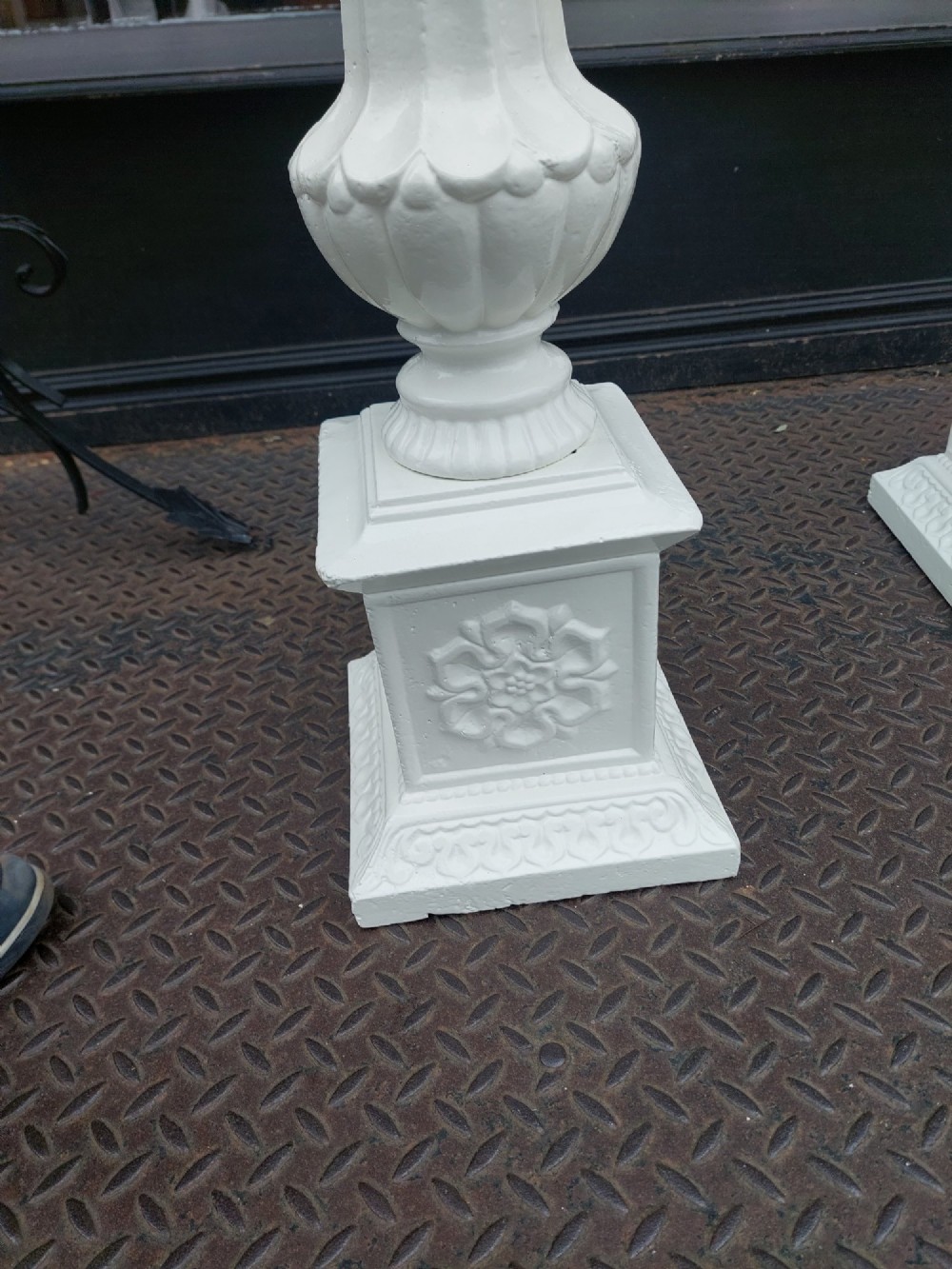 A pair of late 19th-century white painted cast iron garden pedestals with turned column shafts and floral relief square bases. View V