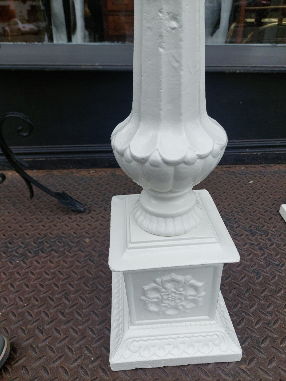 A pair of late 19th-century white painted cast iron garden pedestals with turned column shafts and floral relief square bases. View VI