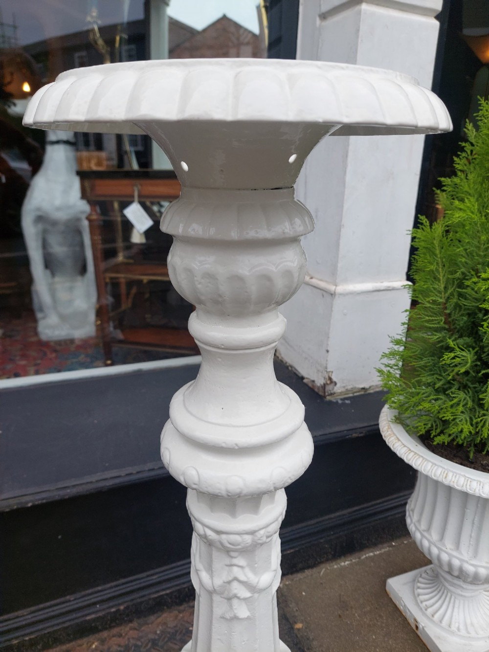 A pair of late 19th-century white painted cast iron garden pedestals with turned column shafts and floral relief square bases. View VII