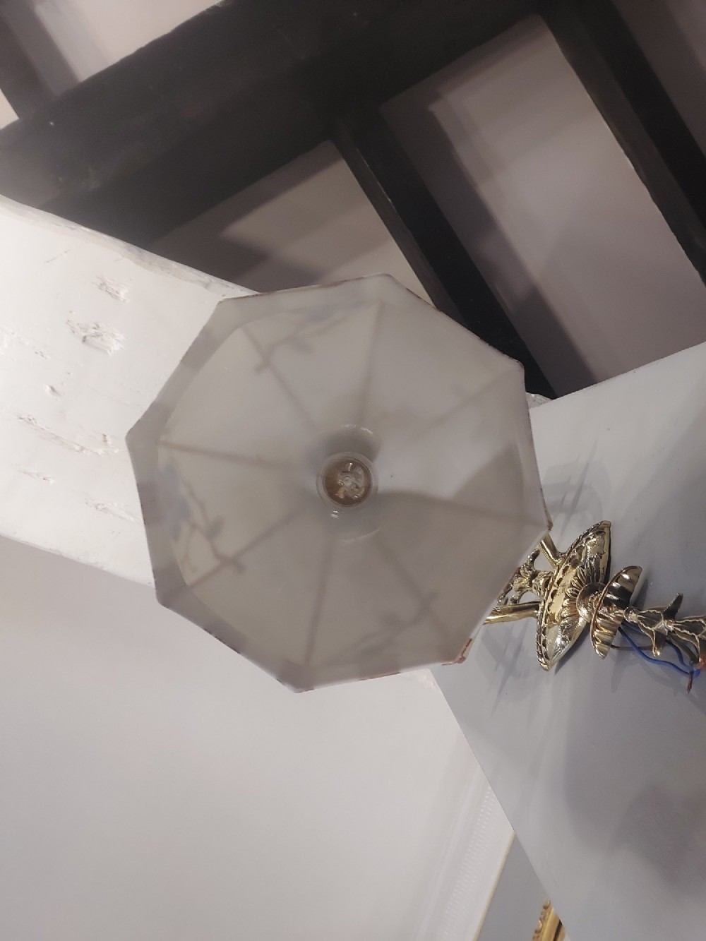 A 1920s cream glass pendant light shade hand painted with blue floral motifs, suspended from a brass chain. View II