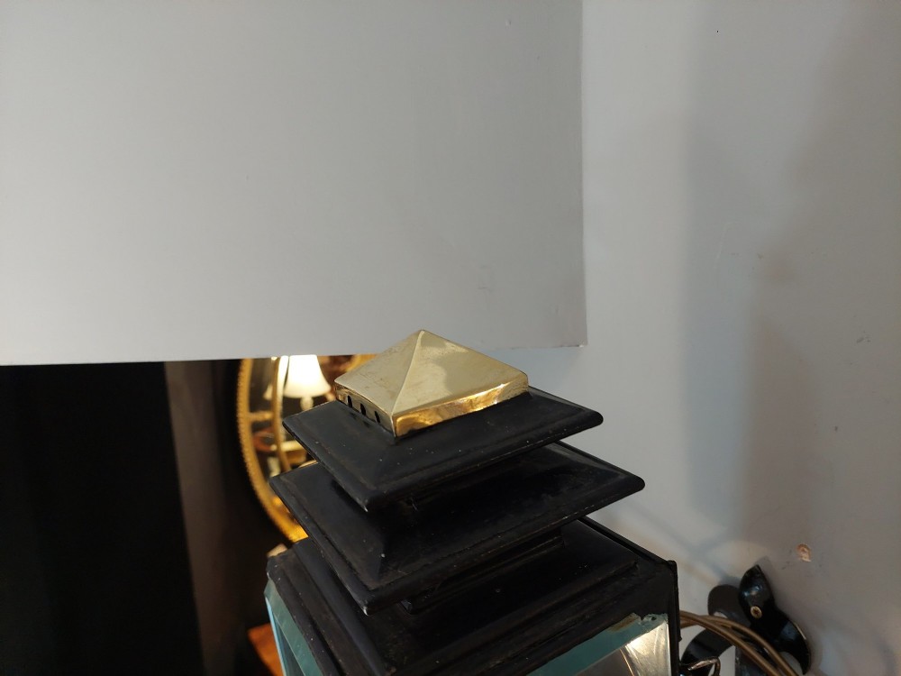 An antique black iron and polished brass carriage lamp mounted on a decorative scrolled wall bracket with bevelled glass panels. View V