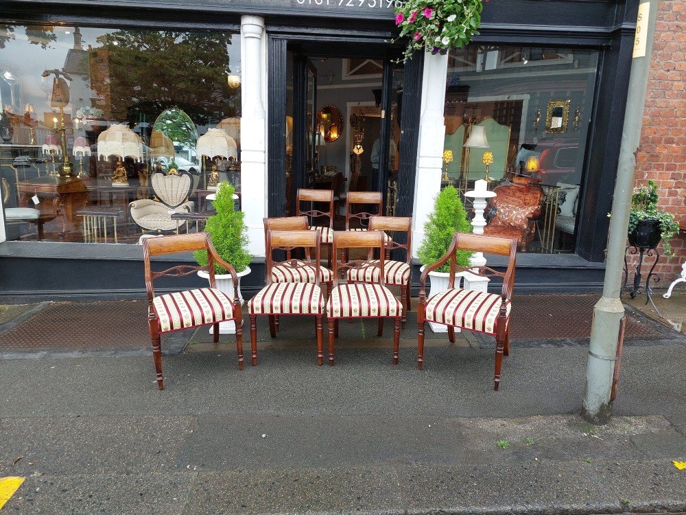 A Regency mahogany extendable dining table surrounded by matching dining chairs with striped upholstered seats. View VII