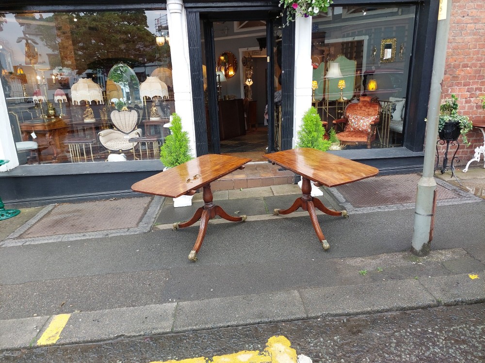 A Regency mahogany extendable dining table surrounded by matching dining chairs with striped upholstered seats. View XV