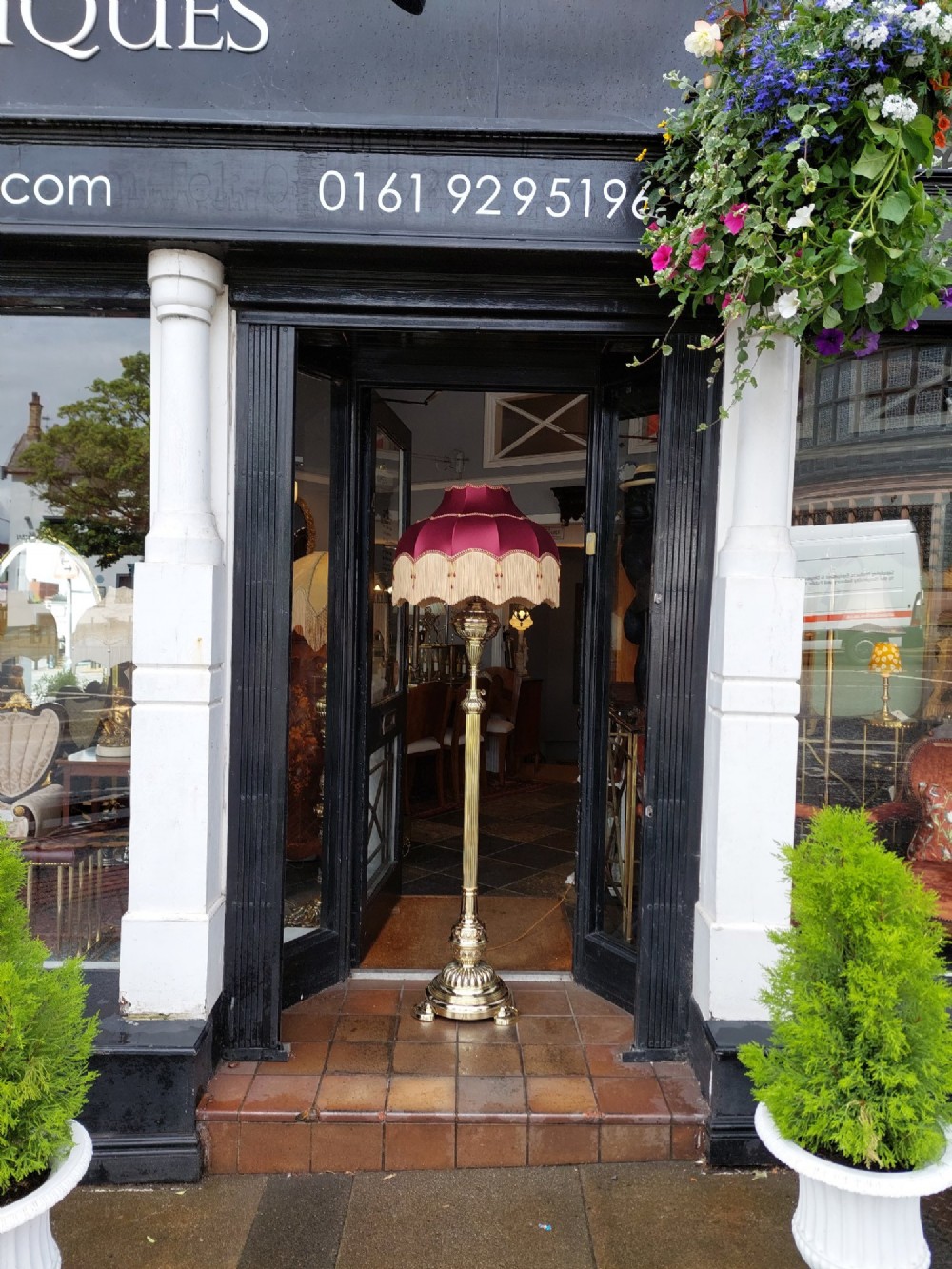 A Victorian brass extending standard floor lamp featuring a fluted column base and a deep red fabric shade with fringe detailing. View IX