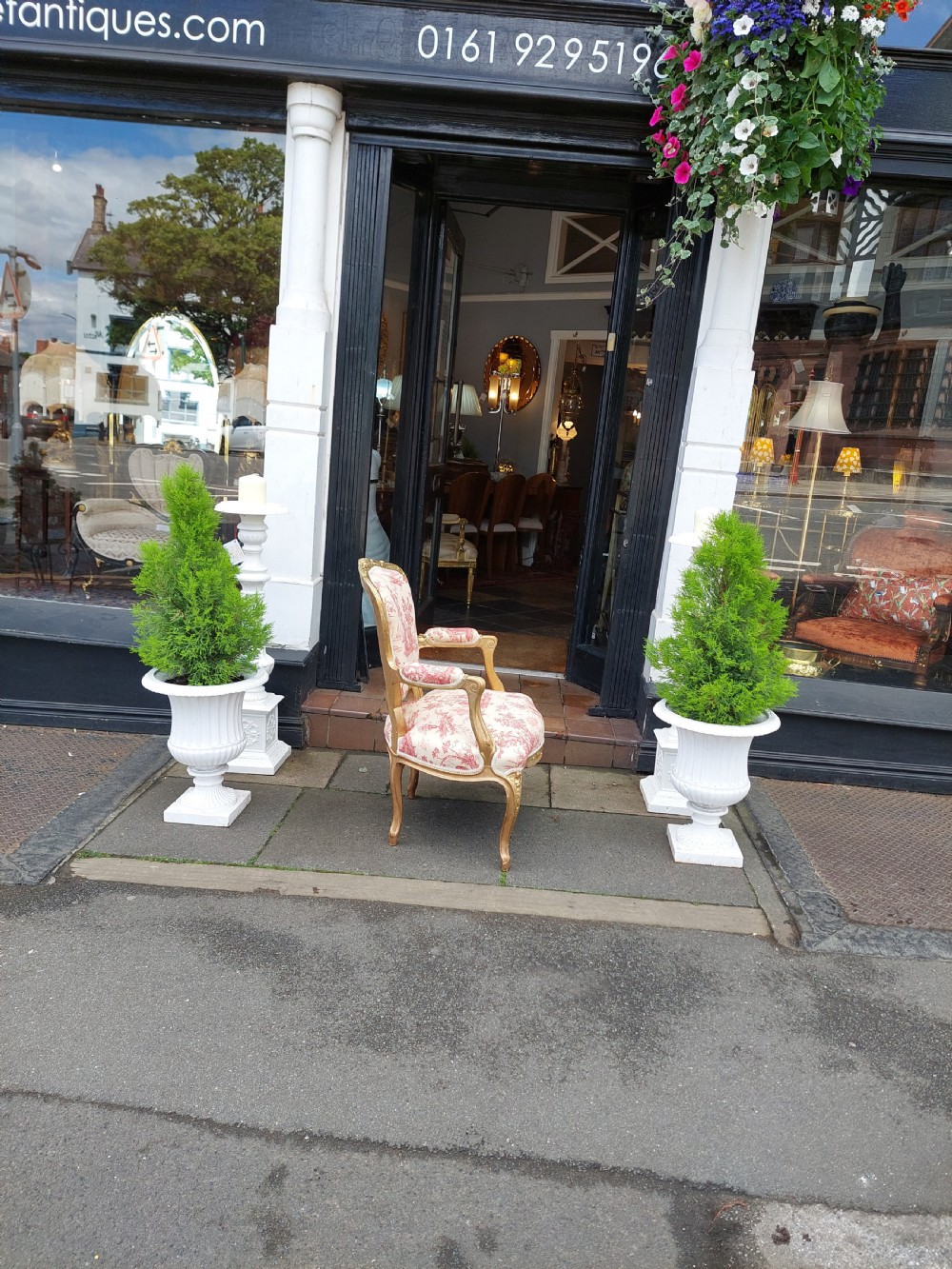 A late 19th-century French Rococo Revival giltwood open armchair upholstered in red and white Toile de Jouy patterned fabric featuring cabriole legs and floral carvings. View IX