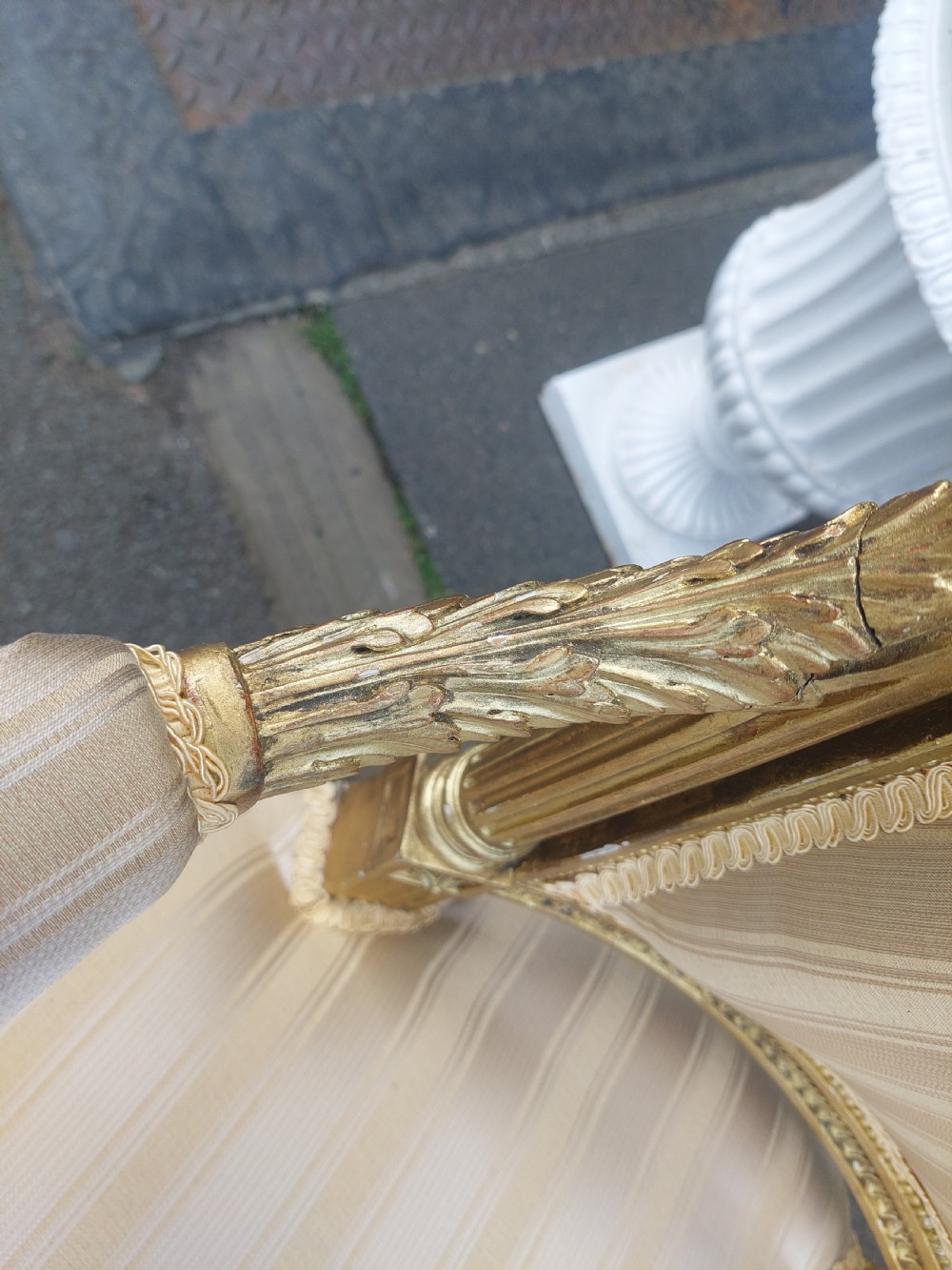 A mid-Victorian giltwood fauteuil armchair with carved golden wood framing, fluted legs, and cream striped upholstery. View VI