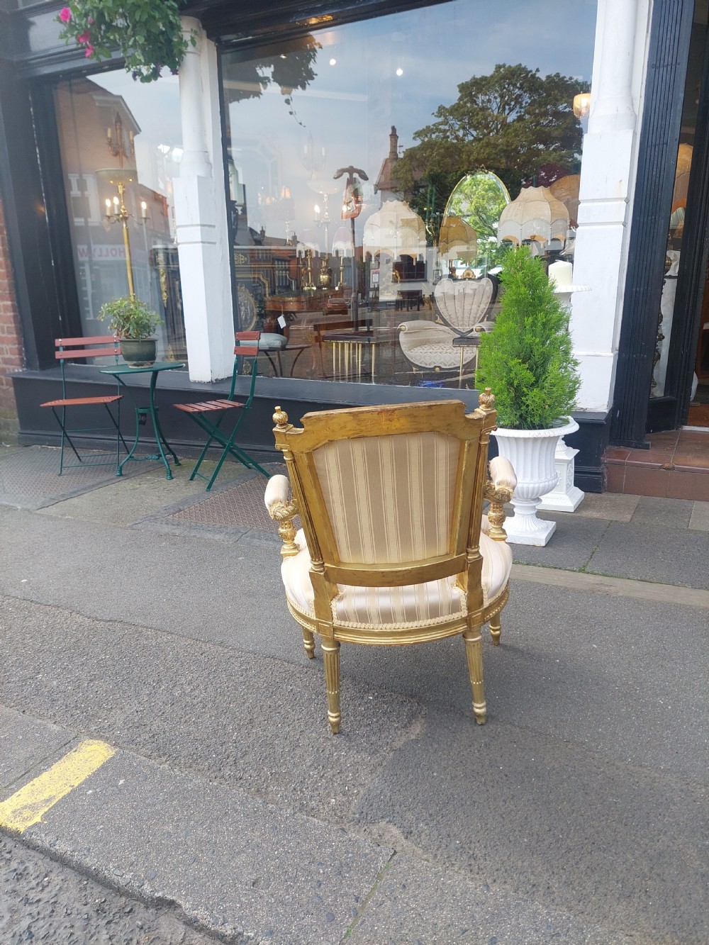 A mid-Victorian giltwood fauteuil armchair with carved golden wood framing, fluted legs, and cream striped upholstery. View VII