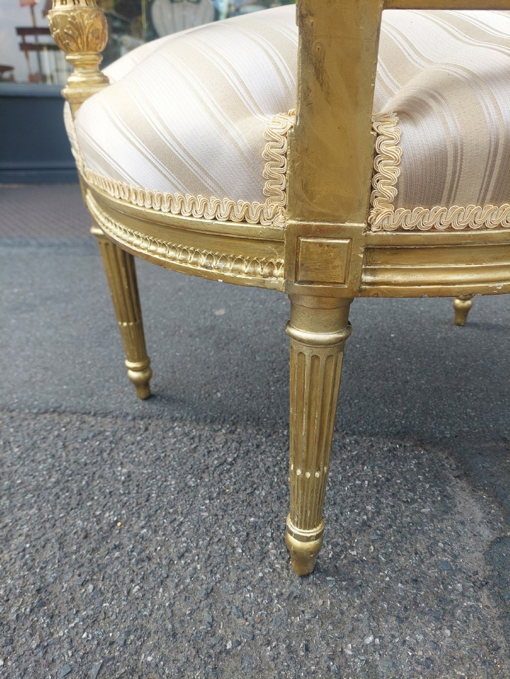 A mid-Victorian giltwood fauteuil armchair with carved golden wood framing, fluted legs, and cream striped upholstery. View VIII