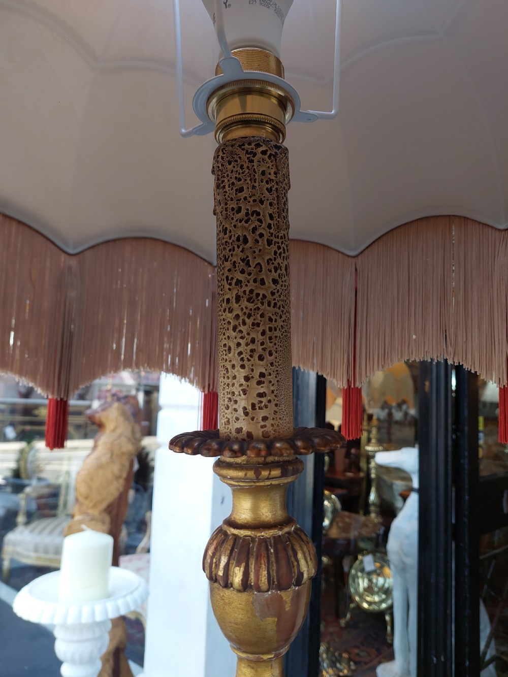 A tall Neoclassical giltwood standard lamp featuring a reeded column, an urn knop, carved tripod legs, and a fabric shade with tasselled fringe. View VII