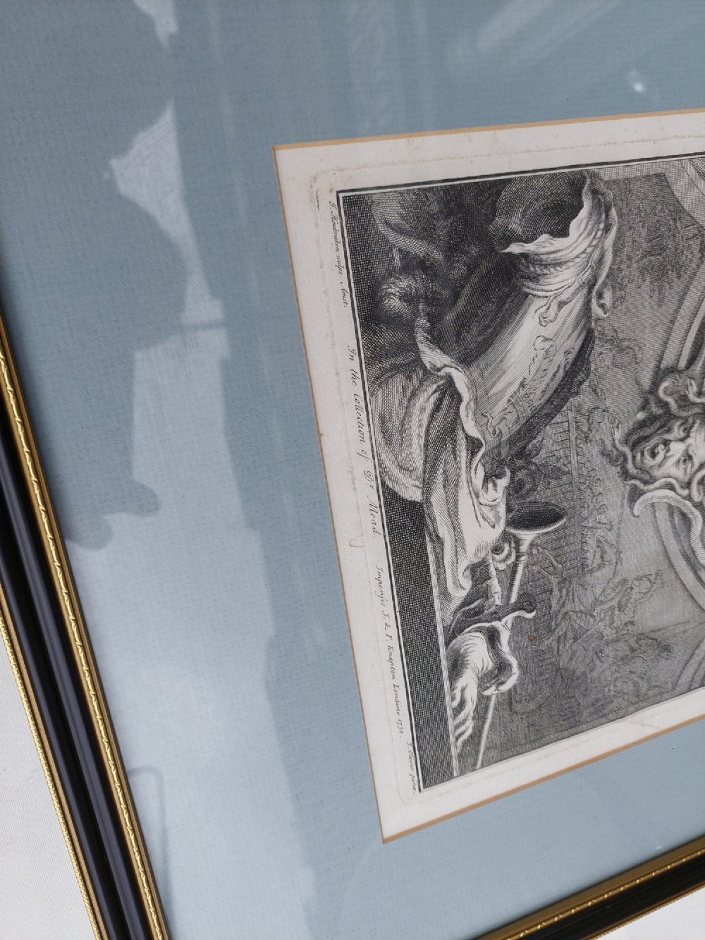 A pair of framed 18th-century line engravings by Jacobus Houbraken depicting oval portrait busts inside architectural surrounds with blue mounts and black frames. View II