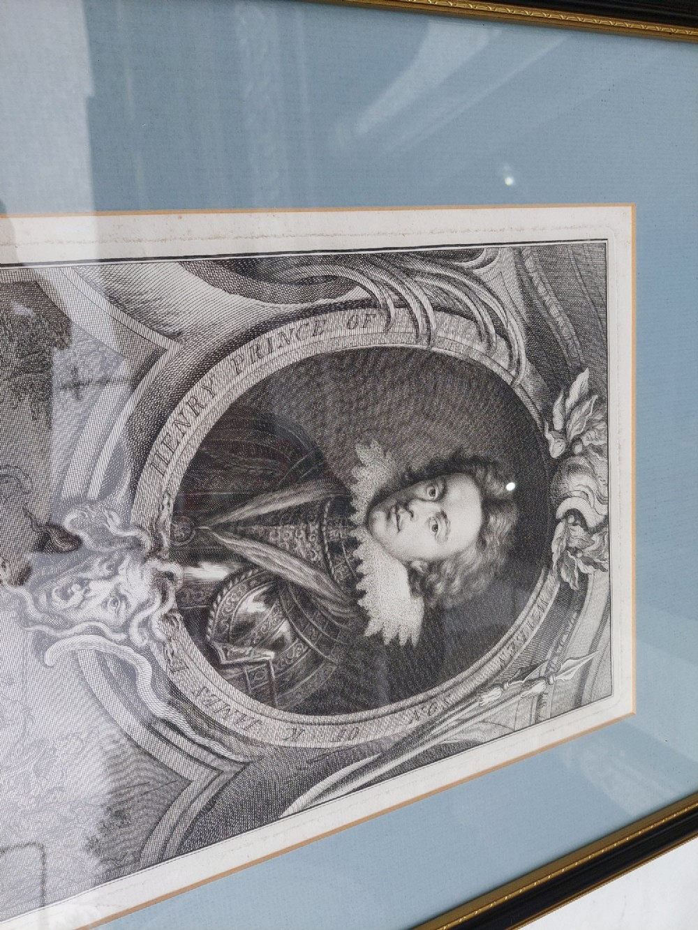 A pair of framed 18th-century line engravings by Jacobus Houbraken depicting oval portrait busts inside architectural surrounds with blue mounts and black frames. View III