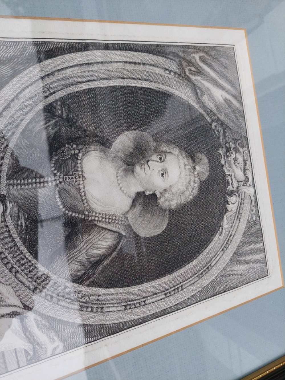 A pair of framed 18th-century line engravings by Jacobus Houbraken depicting oval portrait busts inside architectural surrounds with blue mounts and black frames. View V