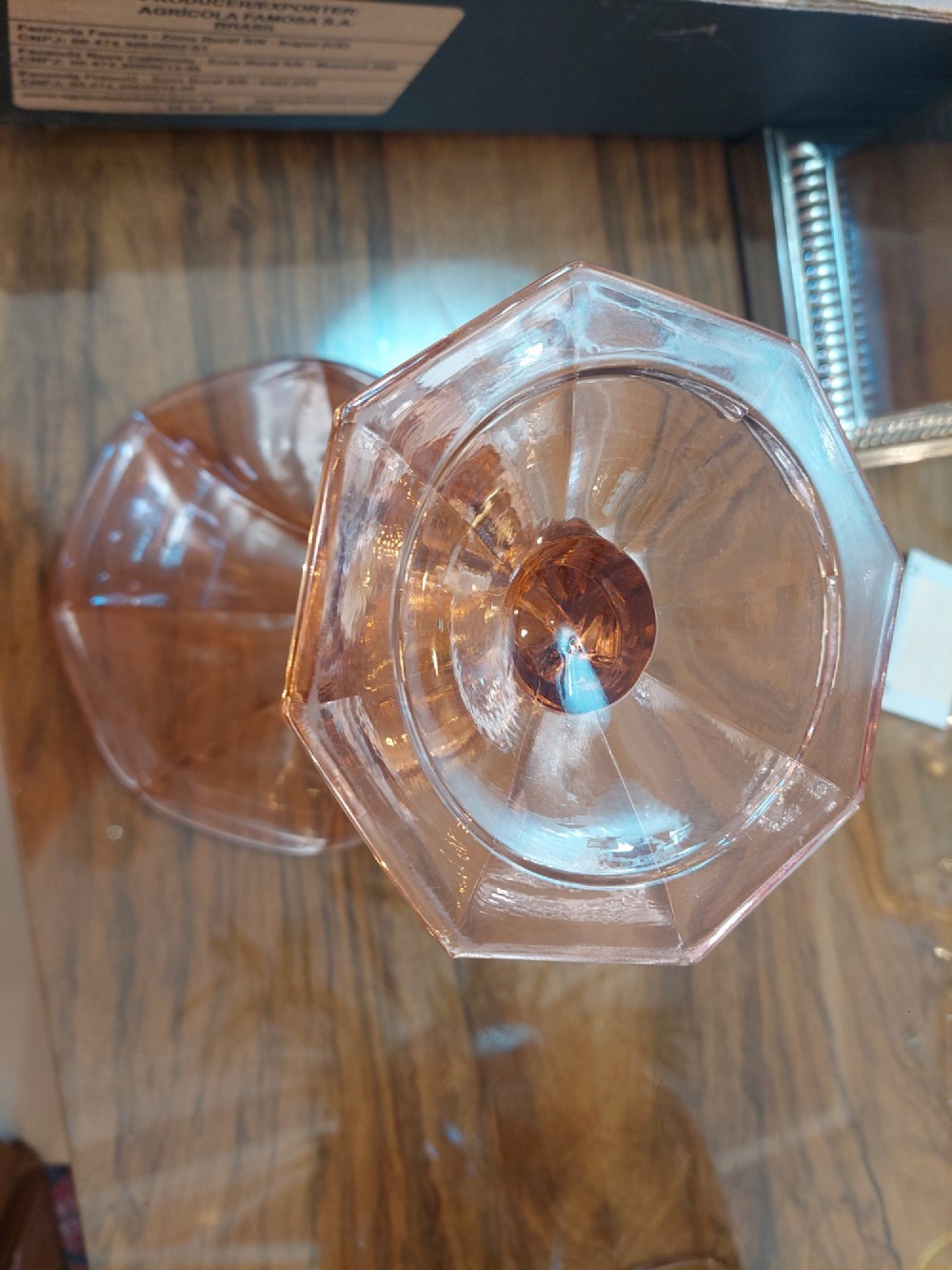 A translucent pink pressed glass vase featuring a flared fluted top supported by a figural stem and a hexagonal base. View II