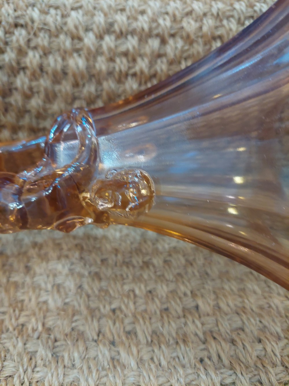 A translucent pink pressed glass vase featuring a flared fluted top supported by a figural stem and a hexagonal base. View V