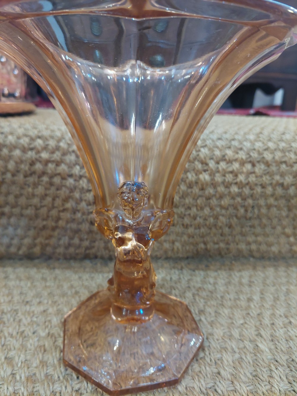 A translucent pink pressed glass vase featuring a flared fluted top supported by a figural stem and a hexagonal base. View VI