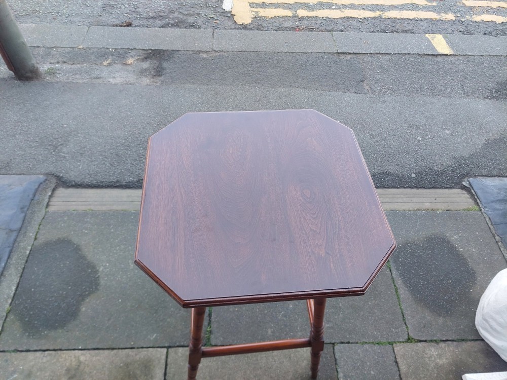 A late Victorian dark walnut pedestal stand featuring an octagonal top supported by four slender ring-turned legs and low box stretchers. View III