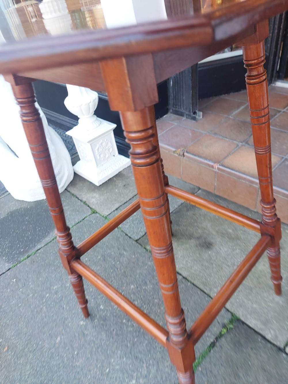 A late Victorian dark walnut pedestal stand featuring an octagonal top supported by four slender ring-turned legs and low box stretchers. View IV