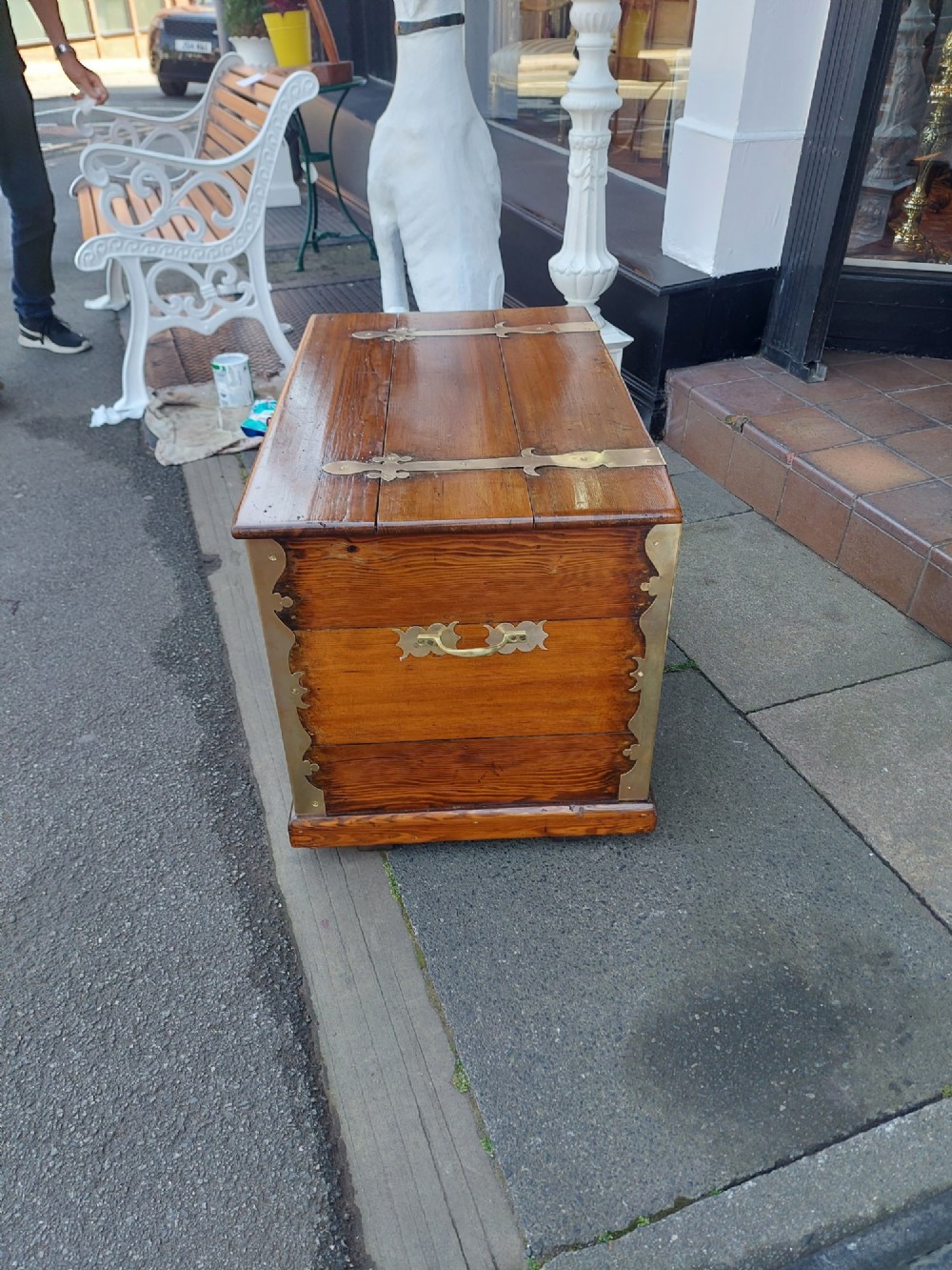 A rectangular Victorian pitch pine storage trunk featuring reinforced brass corner straps, strap hinges, side handles, and a keyhole with a black tassel. View IV
