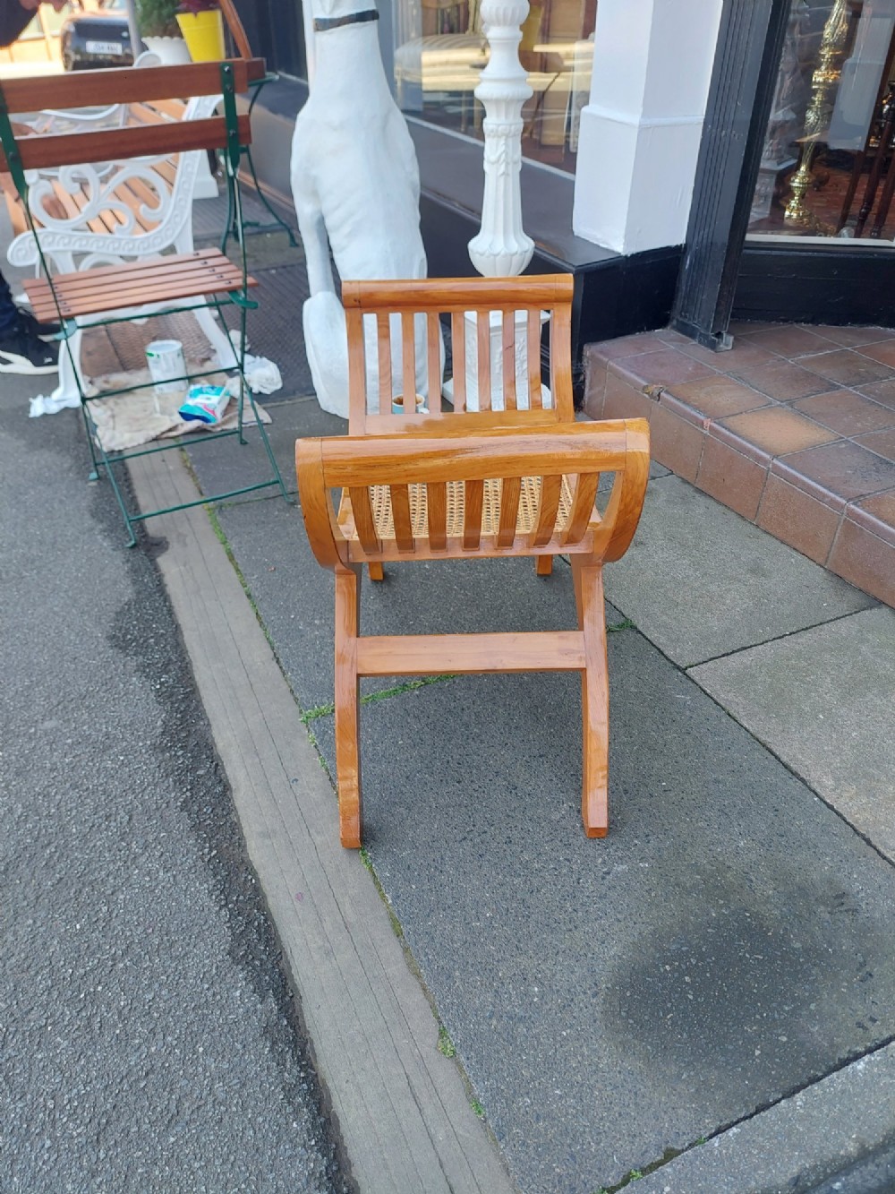 A late nineteenth-century golden satinwood dressing table stool featuring a curved X-frame design, slatted scroll armrests, and a central woven cane seat. View VI