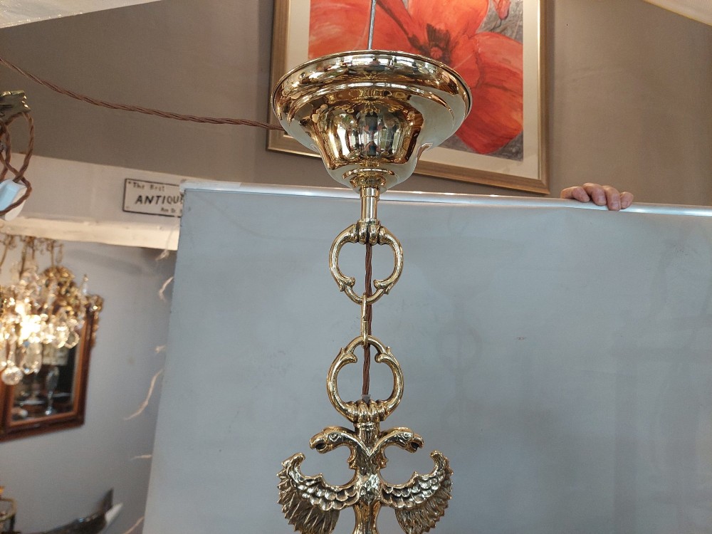 An 18th-century Dutch style polished brass chandelier featuring two tiers of curved arms, candle-style bulb holders, a central baluster stem, and a double-headed eagle crest. View IV