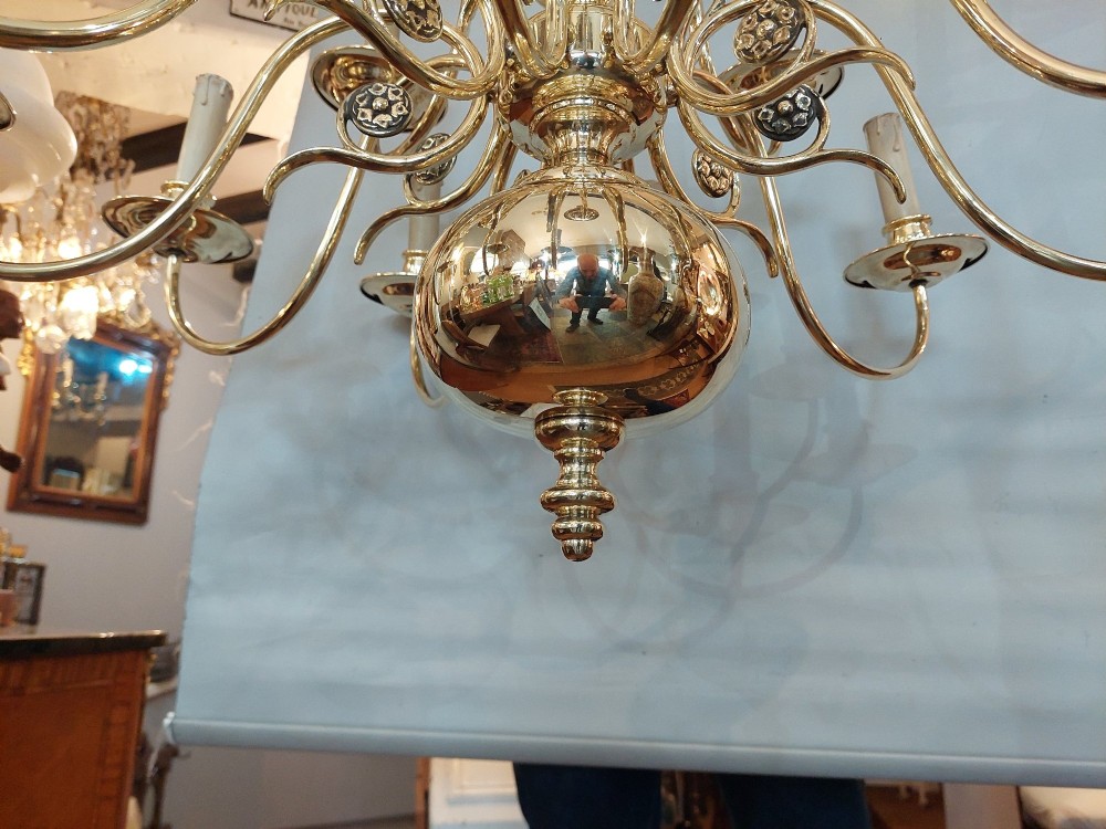 An 18th-century Dutch style polished brass chandelier featuring two tiers of curved arms, candle-style bulb holders, a central baluster stem, and a double-headed eagle crest. View VI